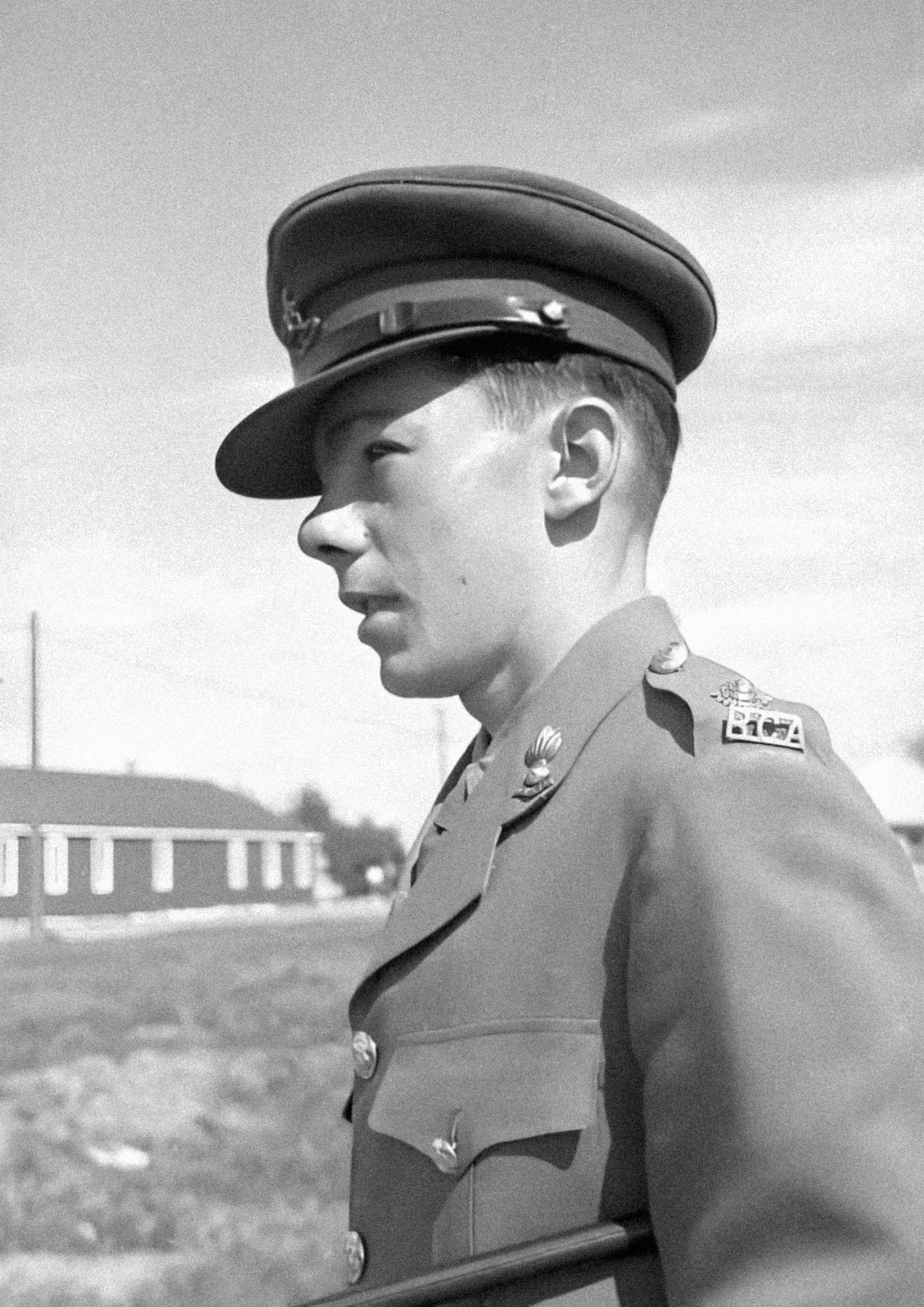 Archival studio portrait of a young man in military uniform, mid-20th century